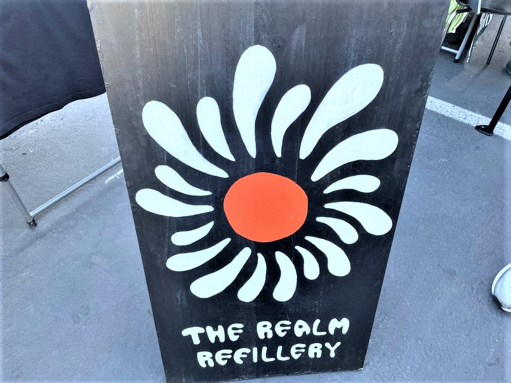 The Realm Refillery sign at Vegan Night Market in Portland. Photo by Karen Chow.